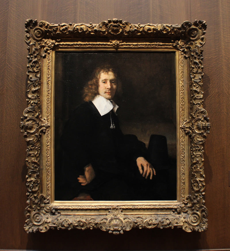 A Young Man Seated at a Table (possibly Govaert Flinck)