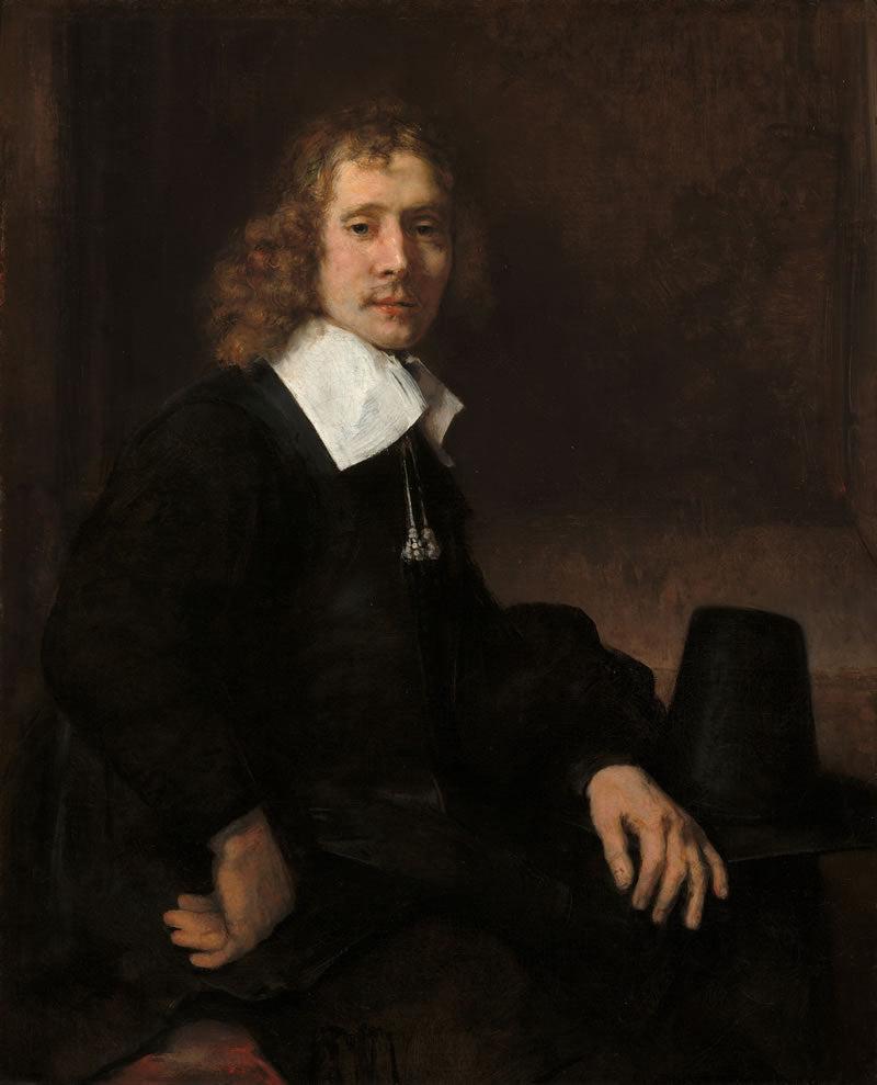 Portrait of a man in formal attire with a dark background