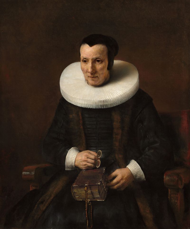 Portrait of a person wearing a white ruffled collar and dark clothing, holding a leather-bound book.