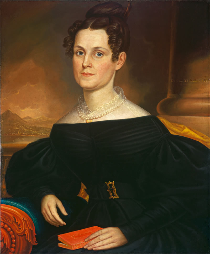 Portrait of a woman in a dark dress with a pearl necklace, sitting on a decorative chair.