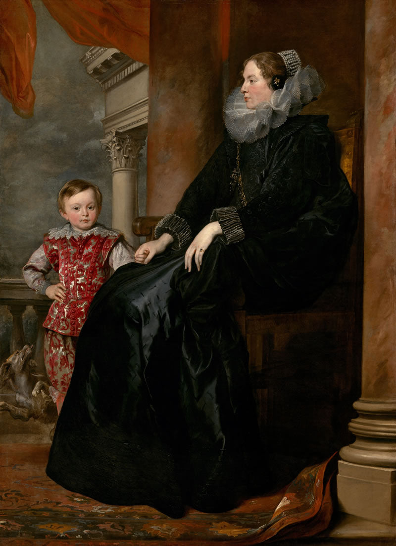 Portrait of a woman in a dark dress with a child in a red outfit in an interior setting.