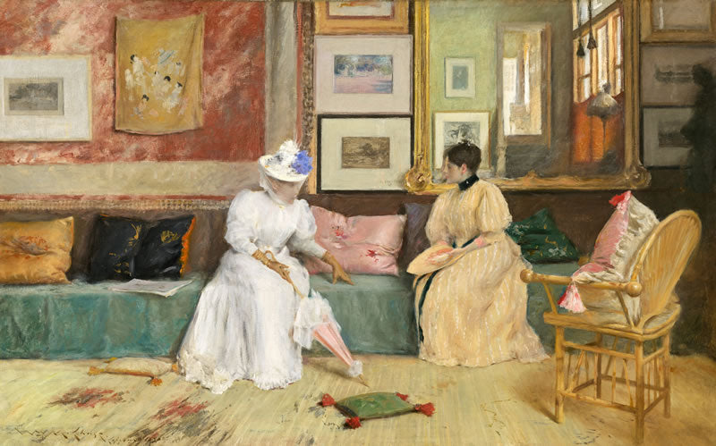 Two women in a room with decorative elements and artwork on the walls.