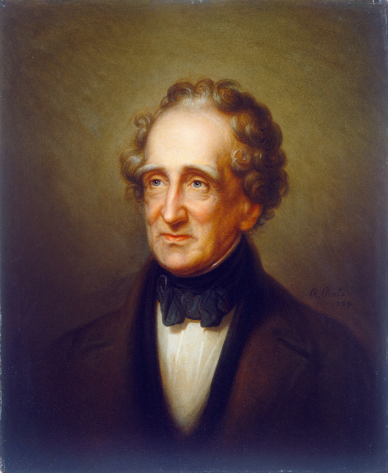 Portrait of a man with curly hair and a dark suit against a brown background