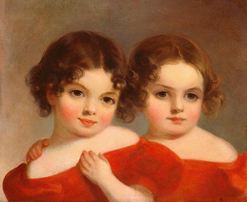 Portrait of two young girls in red dresses against a neutral background