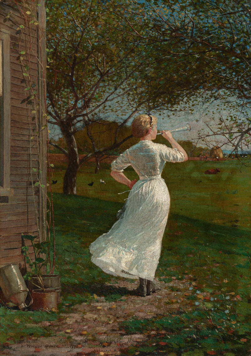 Woman in a white dress blowing bubbles in a garden setting