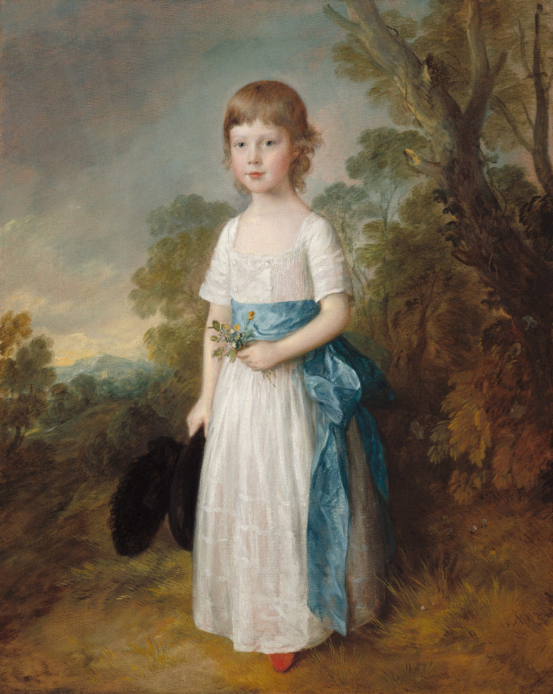 Portrait of a young girl in a white dress with a blue sash, standing outdoors in a natural setting.