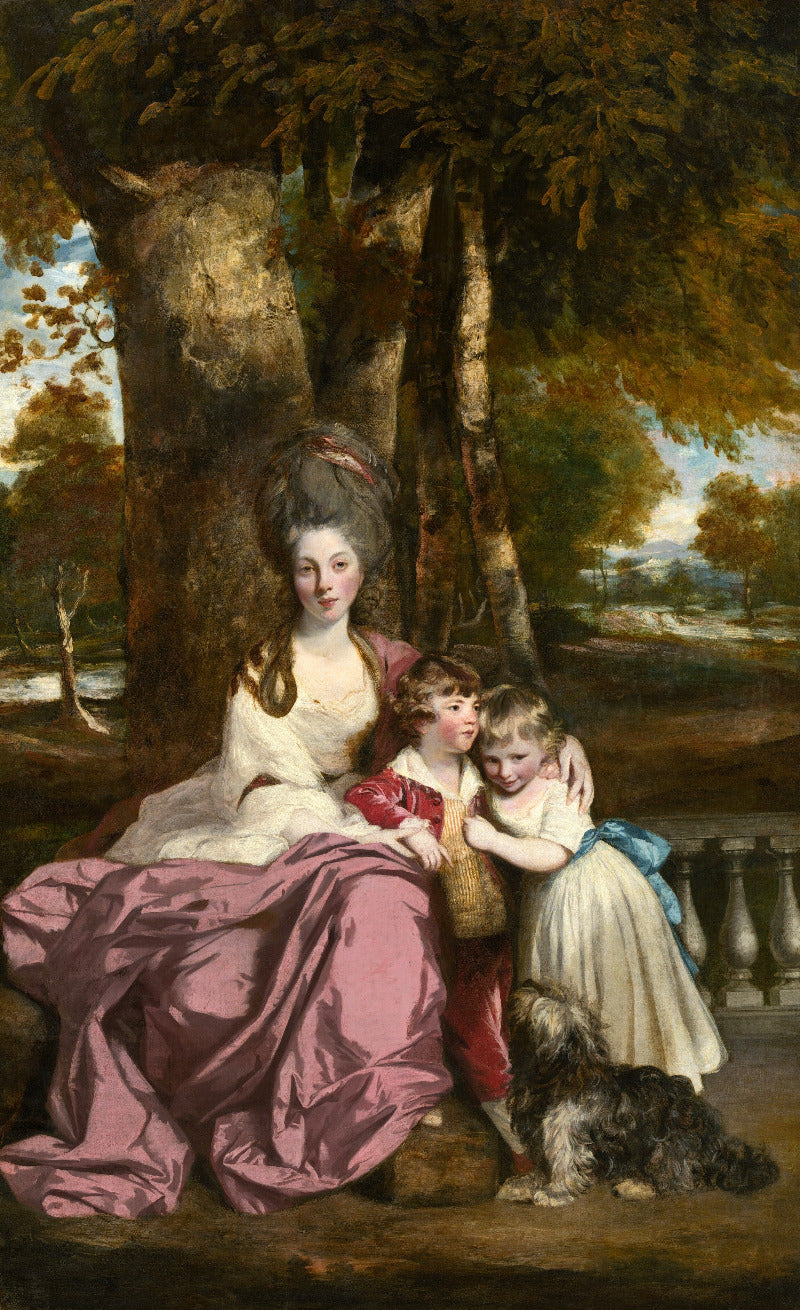 Portrait of a woman with two children and a dog in an outdoor setting