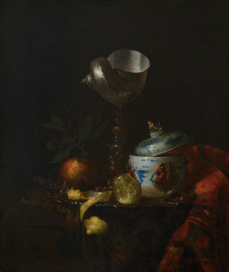 A dark still life painting featuring a silver goblet, a blue-and-white lidded jar, citrus fruits, a red apple, and a draped red fabric against a nearly black background.