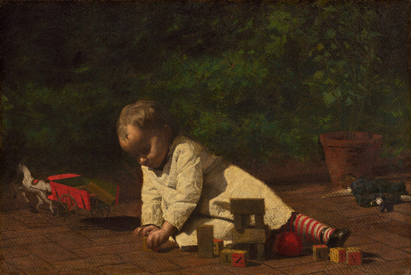 Child playing with toys on a wooden floor with a dark green wall in the background