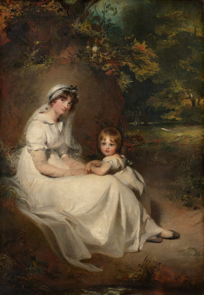 Portrait of a woman and a child in white dresses sitting outdoors with trees and nature in the background.