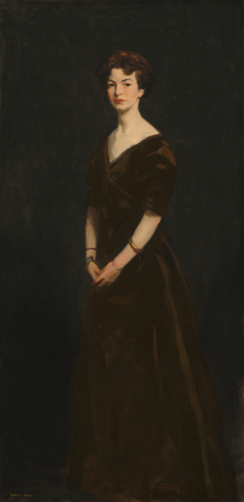 Portrait of a woman in a dark dress against a dark background
