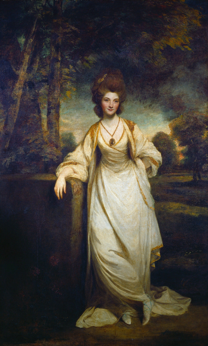 Portrait of a woman in a white dress standing in a natural setting